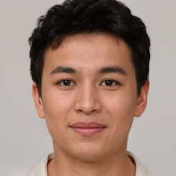 Joyful asian young-adult male with short  brown hair and brown eyes