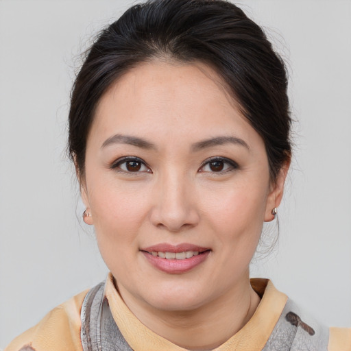 Joyful asian young-adult female with medium  brown hair and brown eyes