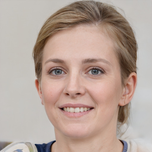 Joyful white young-adult female with medium  brown hair and blue eyes