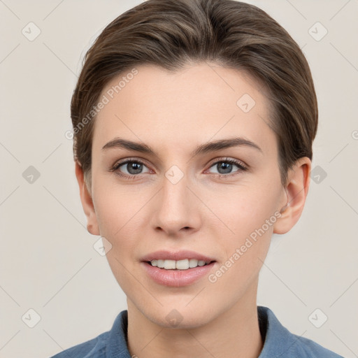 Joyful white young-adult female with short  brown hair and grey eyes