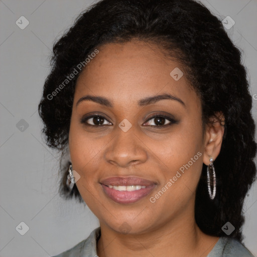 Joyful black young-adult female with long  brown hair and brown eyes