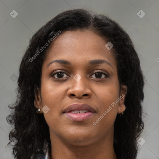 Joyful black young-adult female with long  brown hair and brown eyes