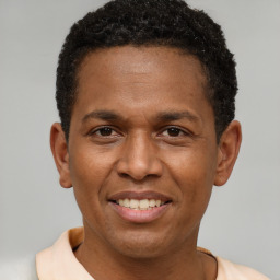 Joyful latino young-adult male with short  brown hair and brown eyes