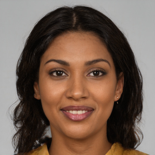 Joyful black young-adult female with medium  brown hair and brown eyes