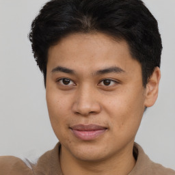 Joyful latino young-adult male with short  brown hair and brown eyes