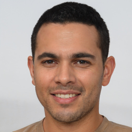 Joyful white young-adult male with short  black hair and brown eyes