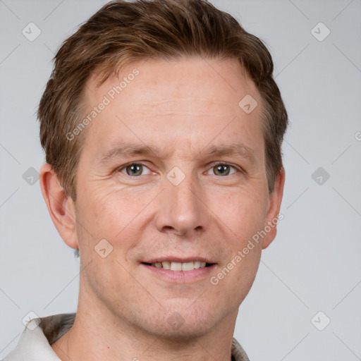 Joyful white adult male with short  brown hair and grey eyes