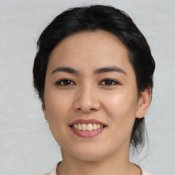 Joyful asian young-adult female with medium  black hair and brown eyes