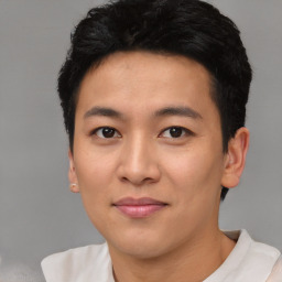 Joyful asian young-adult male with short  black hair and brown eyes