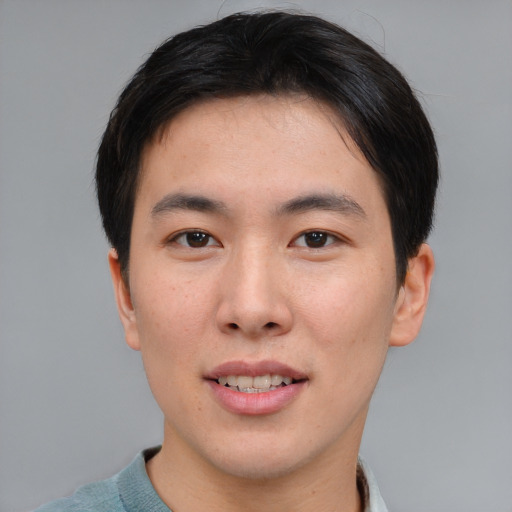 Joyful asian young-adult male with short  brown hair and brown eyes
