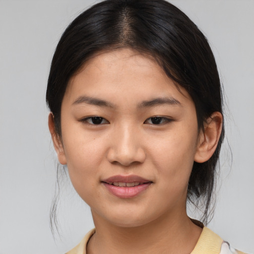Joyful asian young-adult female with medium  brown hair and brown eyes