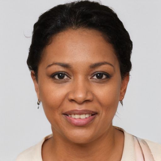Joyful latino young-adult female with short  black hair and brown eyes
