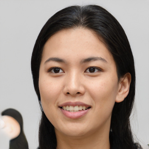 Joyful asian young-adult female with long  brown hair and brown eyes