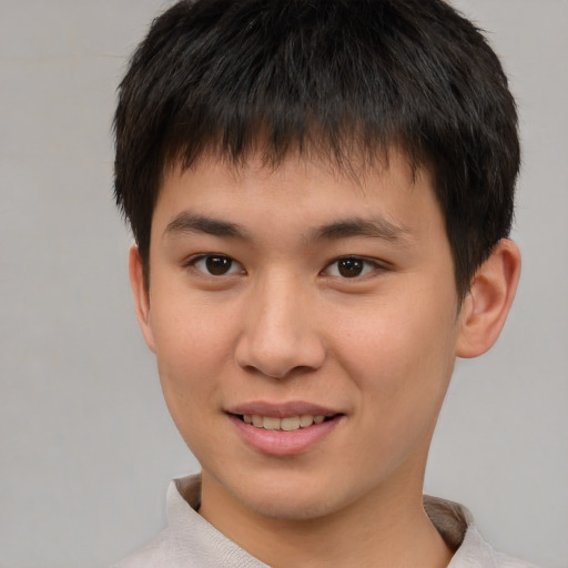 Joyful asian child male with short  brown hair and brown eyes