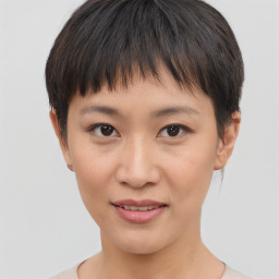 Joyful asian young-adult female with short  brown hair and brown eyes