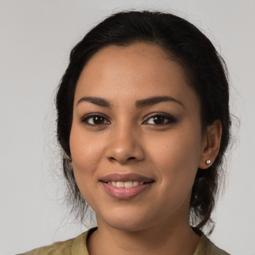 Joyful latino young-adult female with medium  black hair and brown eyes