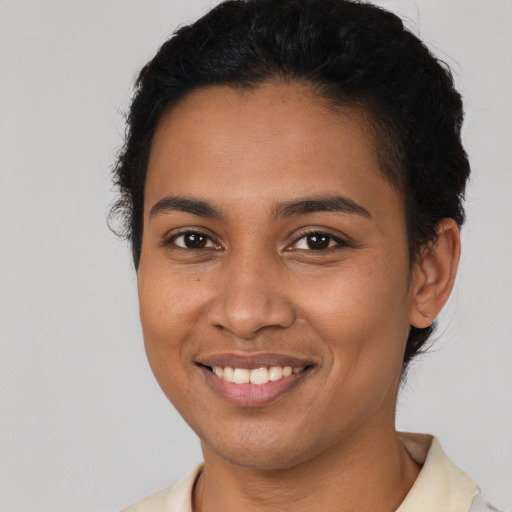 Joyful latino young-adult female with short  brown hair and brown eyes