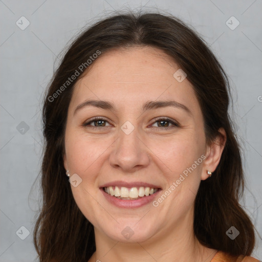 Joyful white adult female with long  brown hair and brown eyes