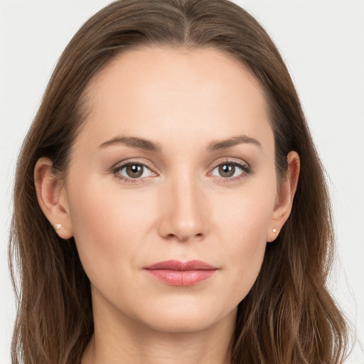 Joyful white young-adult female with long  brown hair and grey eyes