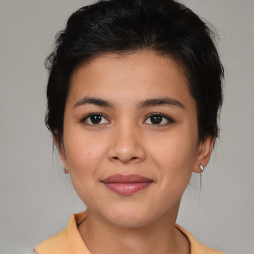 Joyful latino young-adult female with medium  brown hair and brown eyes