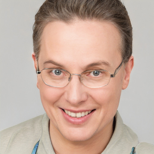 Joyful white adult female with short  brown hair and blue eyes