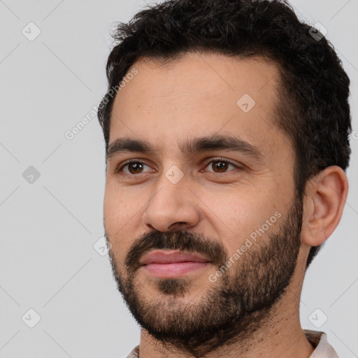 Joyful white young-adult male with short  black hair and brown eyes