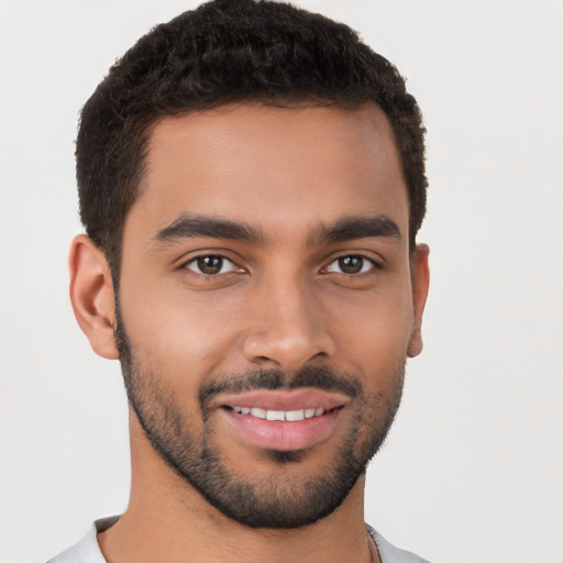 Joyful latino young-adult male with short  brown hair and brown eyes