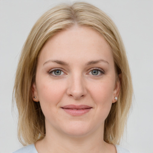 Joyful white young-adult female with medium  brown hair and blue eyes