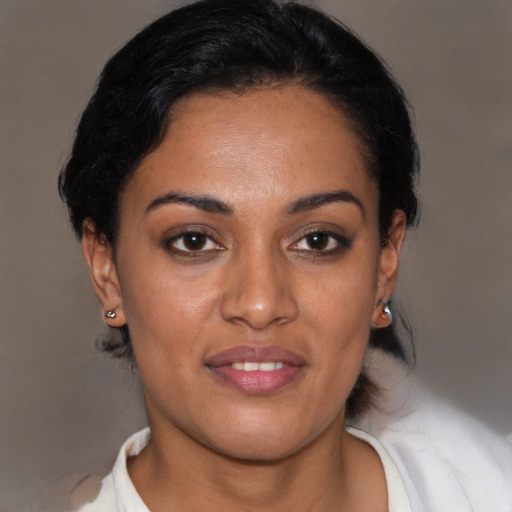 Joyful latino young-adult female with short  black hair and brown eyes