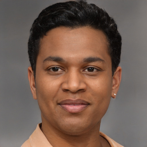 Joyful latino young-adult male with short  black hair and brown eyes