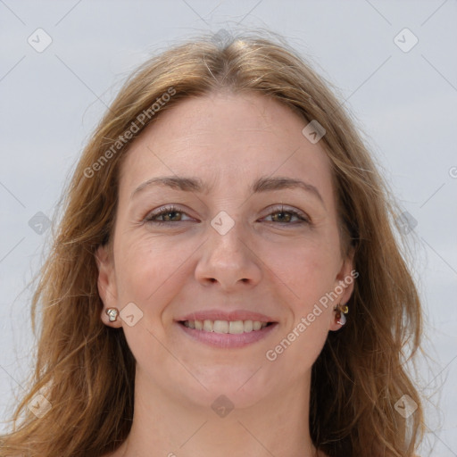 Joyful white adult female with long  brown hair and grey eyes