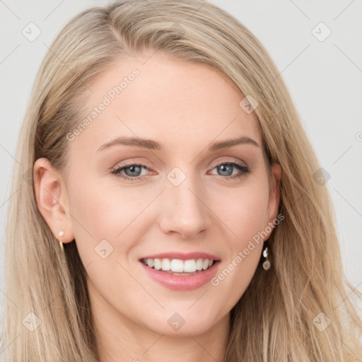 Joyful white young-adult female with long  brown hair and blue eyes