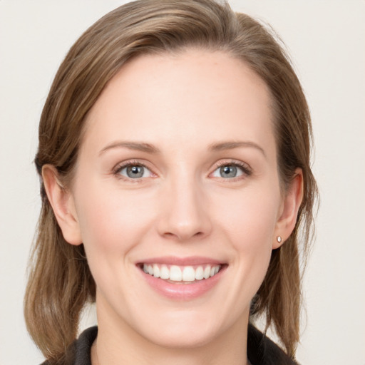 Joyful white young-adult female with long  brown hair and blue eyes