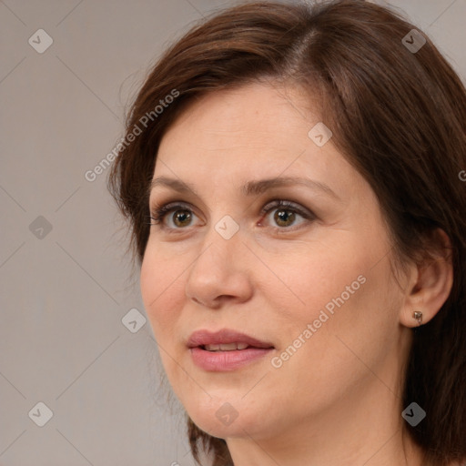 Joyful white adult female with medium  brown hair and brown eyes