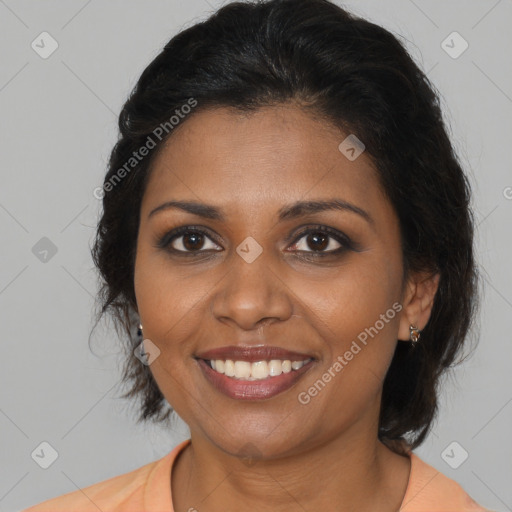 Joyful black adult female with medium  brown hair and brown eyes