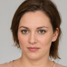 Joyful white young-adult female with medium  brown hair and green eyes