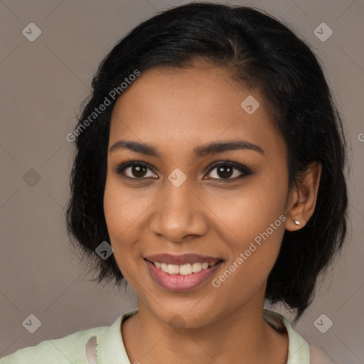 Joyful black young-adult female with long  brown hair and brown eyes