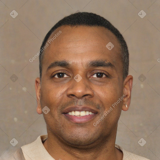Joyful black young-adult male with short  brown hair and brown eyes
