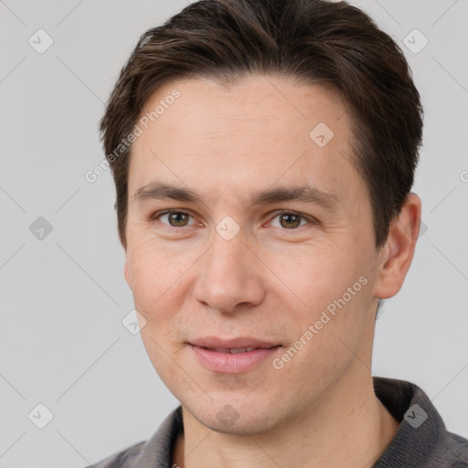 Joyful white adult male with short  brown hair and brown eyes