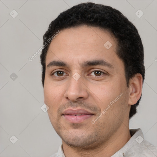 Joyful white young-adult male with short  black hair and brown eyes