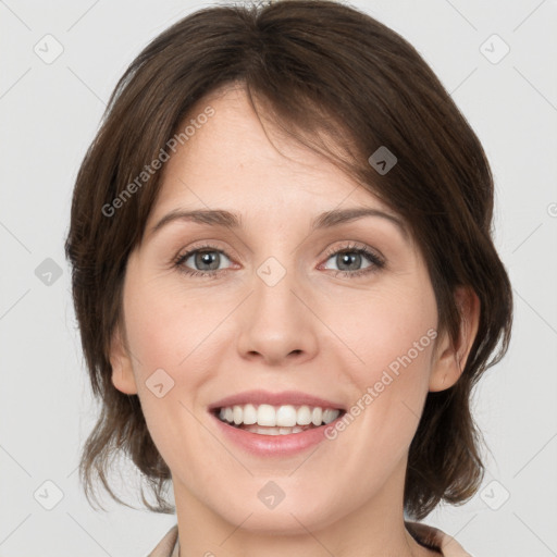 Joyful white young-adult female with medium  brown hair and grey eyes