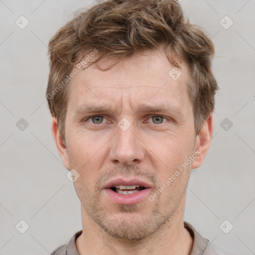 Joyful white adult male with short  brown hair and grey eyes