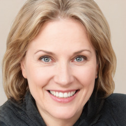 Joyful white young-adult female with medium  brown hair and blue eyes