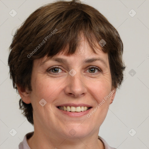 Joyful white adult female with short  brown hair and grey eyes