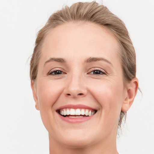 Joyful white young-adult female with medium  brown hair and blue eyes