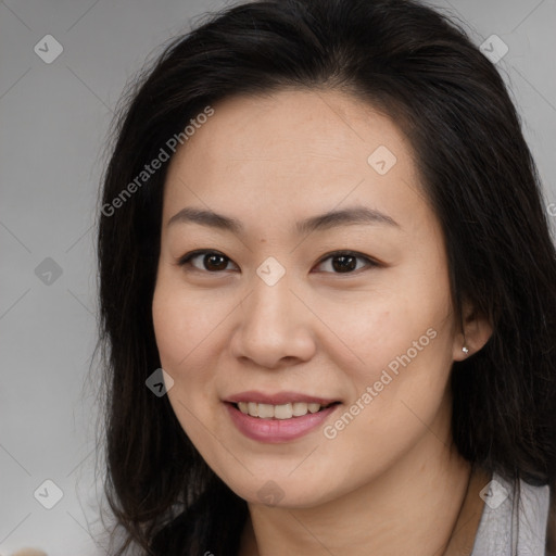 Joyful asian young-adult female with long  brown hair and brown eyes