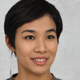 Joyful asian young-adult female with medium  black hair and brown eyes