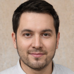 Joyful white young-adult male with short  brown hair and brown eyes