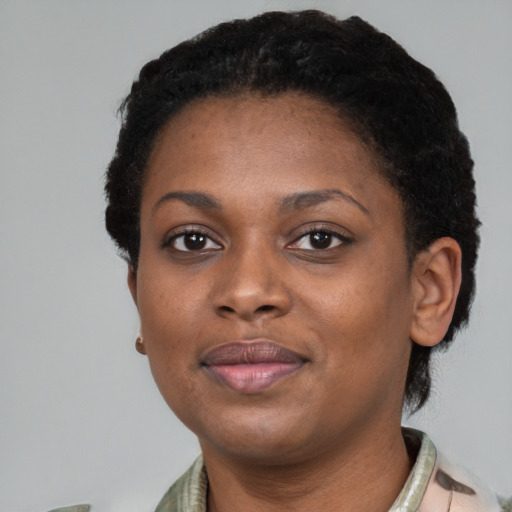 Joyful black young-adult female with short  brown hair and brown eyes