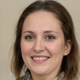 Joyful white adult female with medium  brown hair and grey eyes